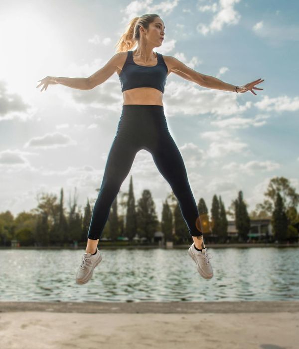 Woman in a dynamic cardio pose, feeling energetic and full of life.